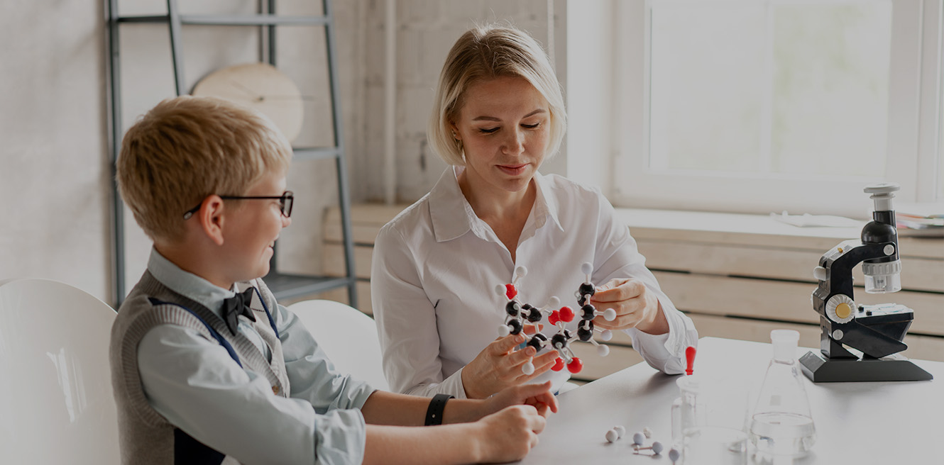 Female science tutor in White Plains studying chemistry with student